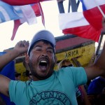 A citizen of the border city of Arica shouts slogans as he gathers with others during the final ruling court session of a decades-old maritime dispute between Peru and Chile, in Arica