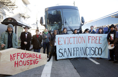Protesters block a bus full of Apple employees during a protest against rising costs of living in San Francisco, California, December 20, 2013. REUTERS/Beck Diefenbach (UNITED STATES - Tags: POLITICS BUSINESS EMPLOYMENT CIVIL UNREST) - RTX16PT6