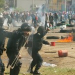 Protesters from the National Coordination of Education Workers (CNTE) teachers’ union clash with riot police officers during a protest, in Nochixtlan