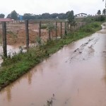 water-from-encroached-waterway-overflowing-into-road