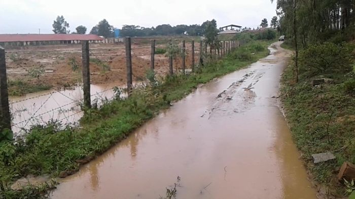 water-from-encroached-waterway-overflowing-into-road