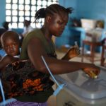 A voter casts her ballot at a polling station during Sierra Leone’s general election in Freetown