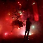 Man enjoys the fireworks exploding from a traditional bull figure known as “El Torito” in Tultepec