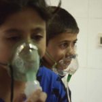 Children, affected by what activists say was a gas attack, breathe through oxygen masks in the Damascus suburb of Saqba