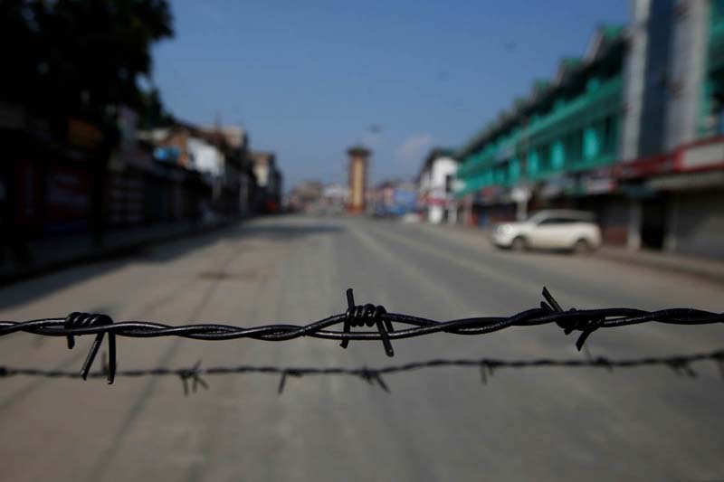 Barbed wire is seen laid on a deserted road during restrictions in Srinagar, August 5, 2019. REUTERS/Danish Ismail TPX IMAGES OF THE DAY 
