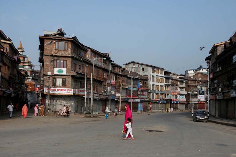 Residents cross a street during restrictions in Srinagar, August 5, 2019. REUTERS/Danish Ismail 