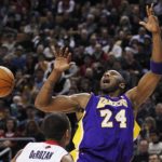 Lakers Bryant  has the ball swatted away by Raptors DeRozan during their NBA basketball game in Toronto
