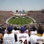 Fans wear Kobe Bryant jerseys at a rally in the Los Angeles Memorial Coliseum