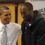 U.S. President Barack Obama slaps Kobe Bryant on the back as they put together care packages for the military and homeless people at the Boys and Girls Club of Washington